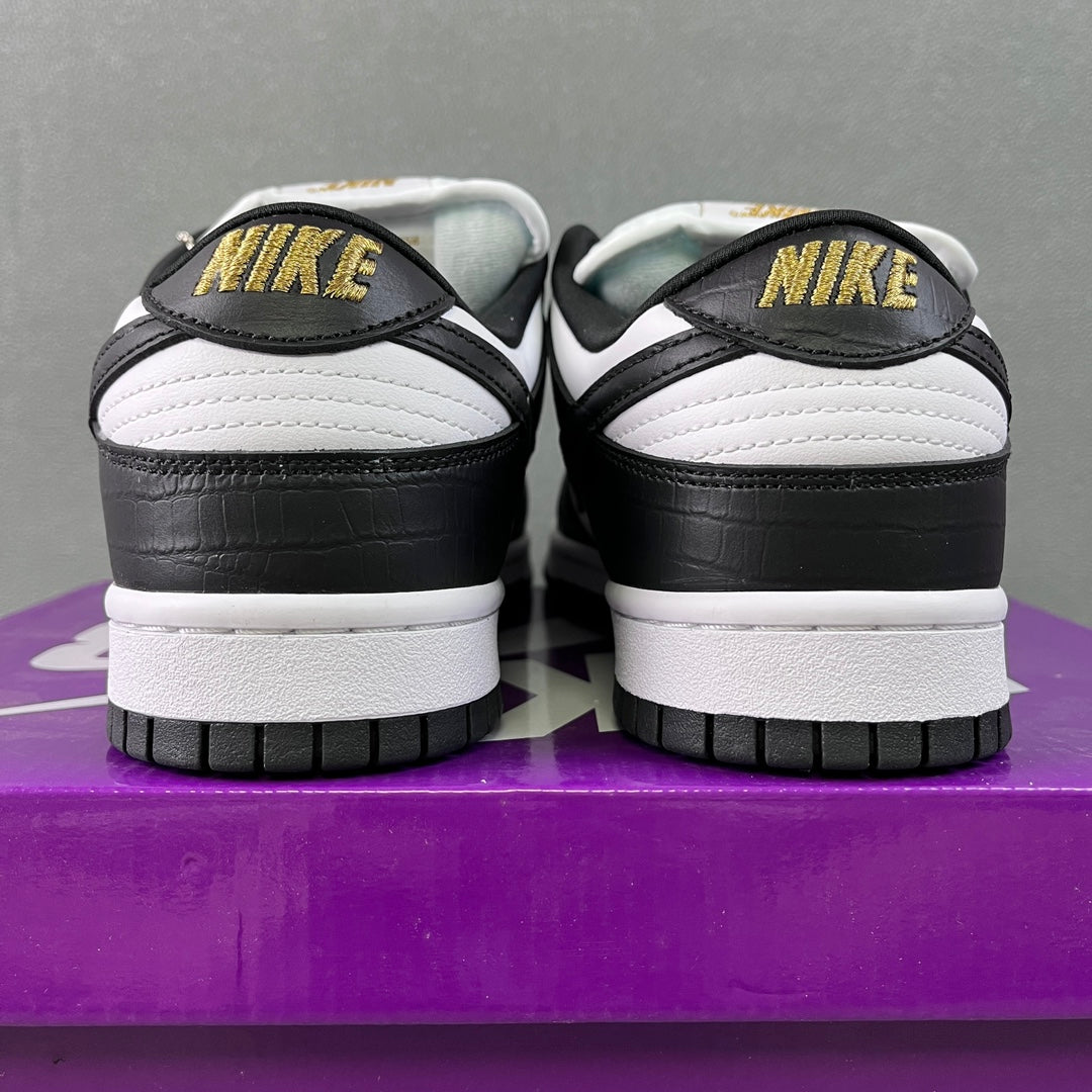 Black and white low-top sneakers with NIKE heel logo and white midsole