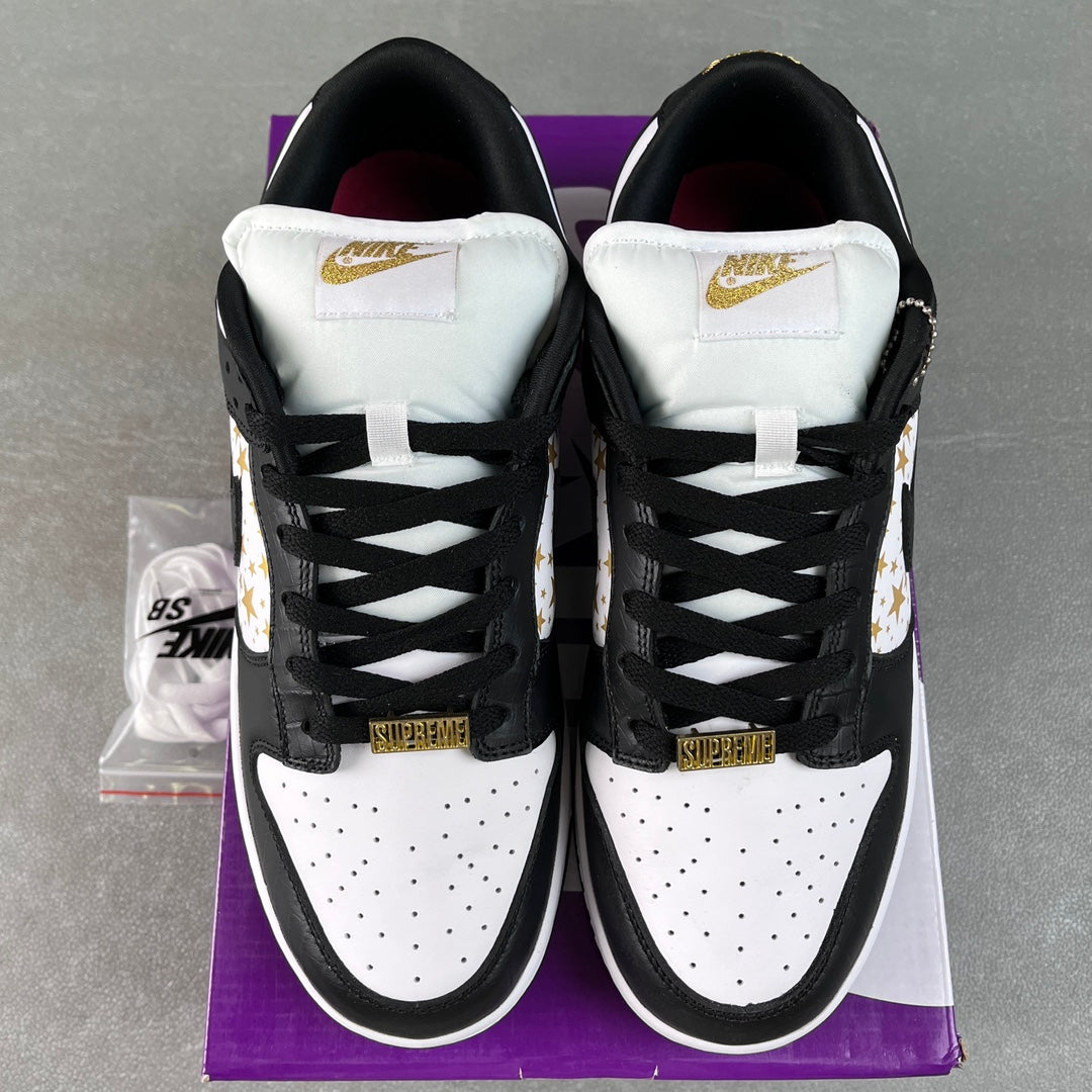 Black and white low-top sneakers with white heel tabs and gold heel accents