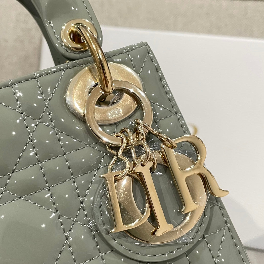 Sage green patent handbag charm detail with gold Dior initials and ring clasp