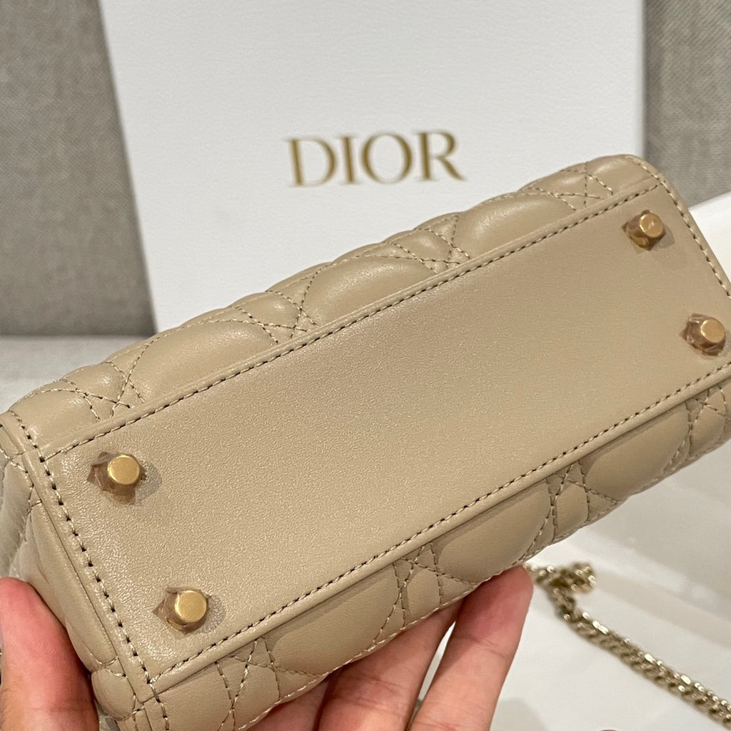 Beige quilted Dior bag front with stud buttons and top flap