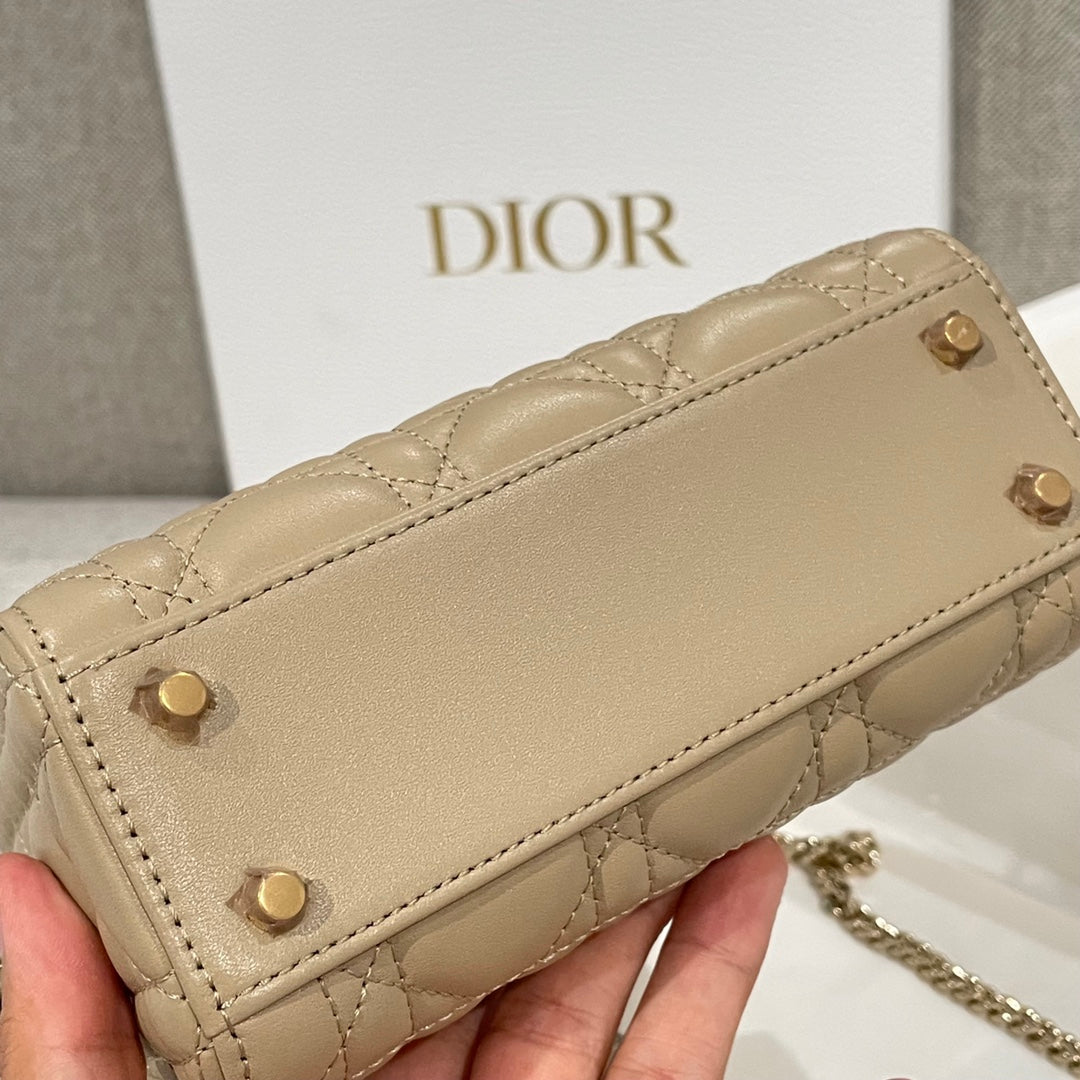 Beige quilted Dior bag front with stud buttons and top flap