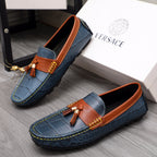 Versace blue loafers with orange trim, tassel ornament, and decorative stitching