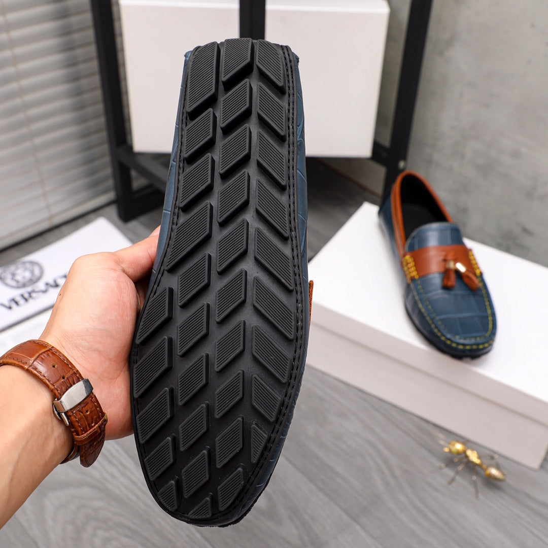 Versace loafer bottom with textured rubber tread and orange trim detail