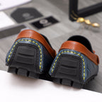 Versace loafer outsoles with textured tread and orange leather heel straps