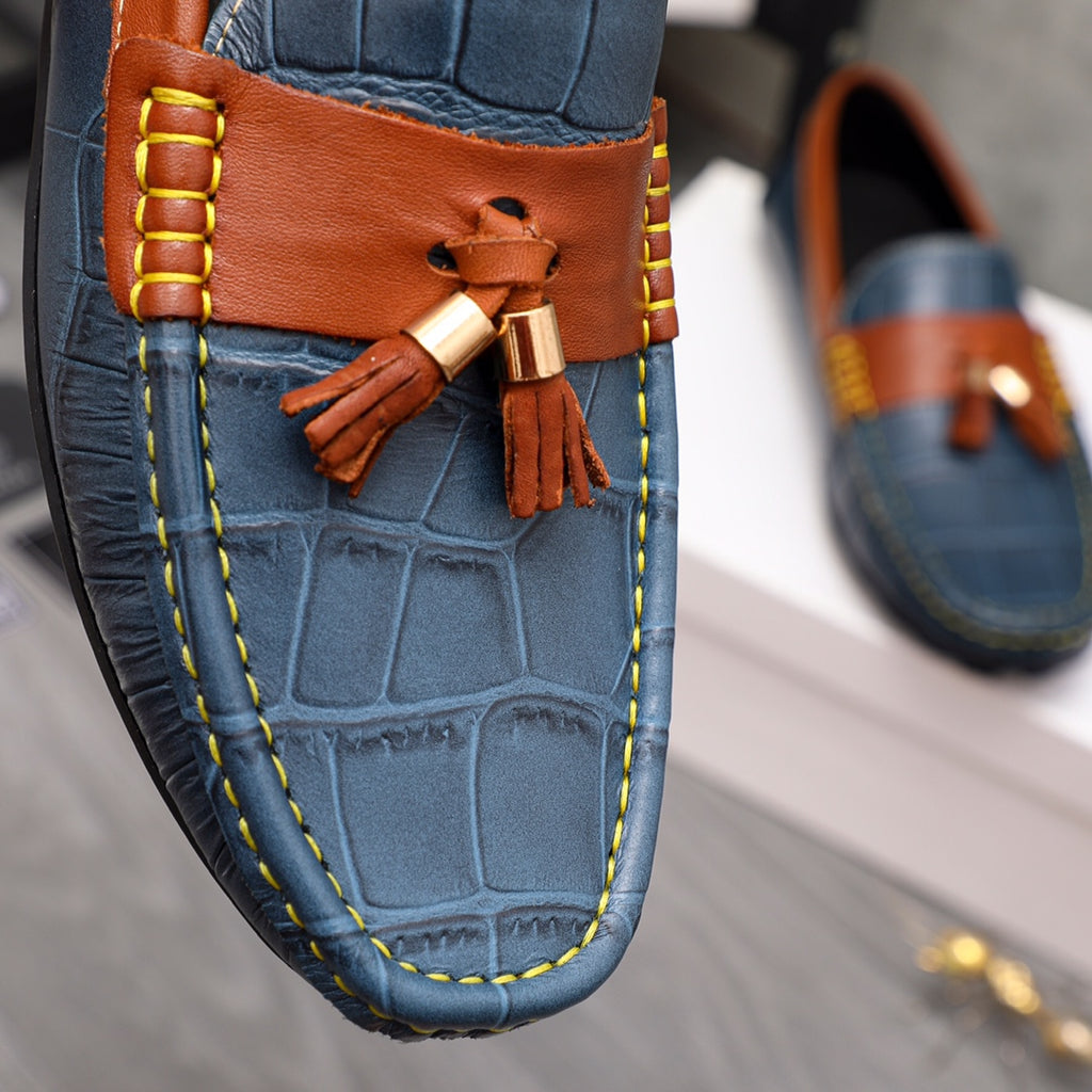Versace blue leather loafer front with orange panel, tassel charm, and metal buckle