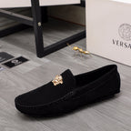 Black suede loafer with gold Medusa crest and stitched moccasin seams
