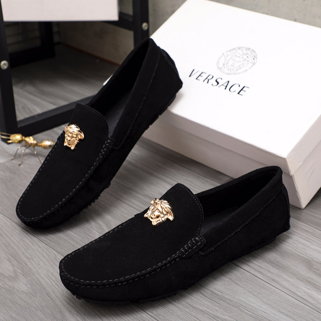 Pair of black suede loafers with gold Medusa crest and stitched side seam