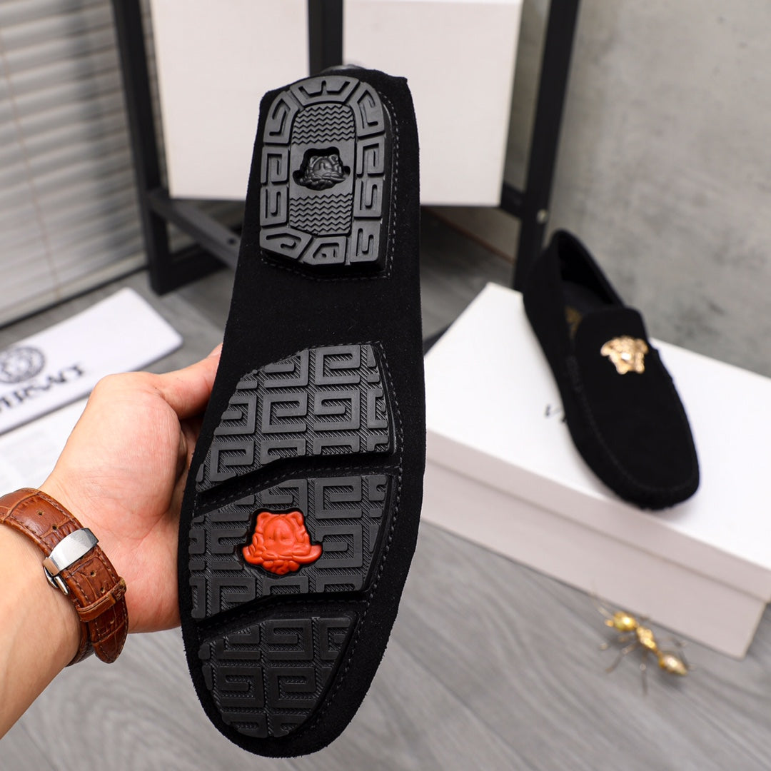Black rubber outsole with patterned tread and orange logo detail