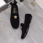 Black suede loafers with gold Medusa crest and thick rubber sole