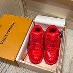 Louis Vuitton red trainer sneakers in a box with visible laces and blue sock lining