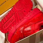 Louis Vuitton red trainer outsole close-up with embossed logo pattern on tread