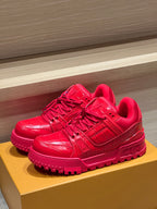 Louis Vuitton red trainer sneakers with lace-up front and chunky treaded sole on display