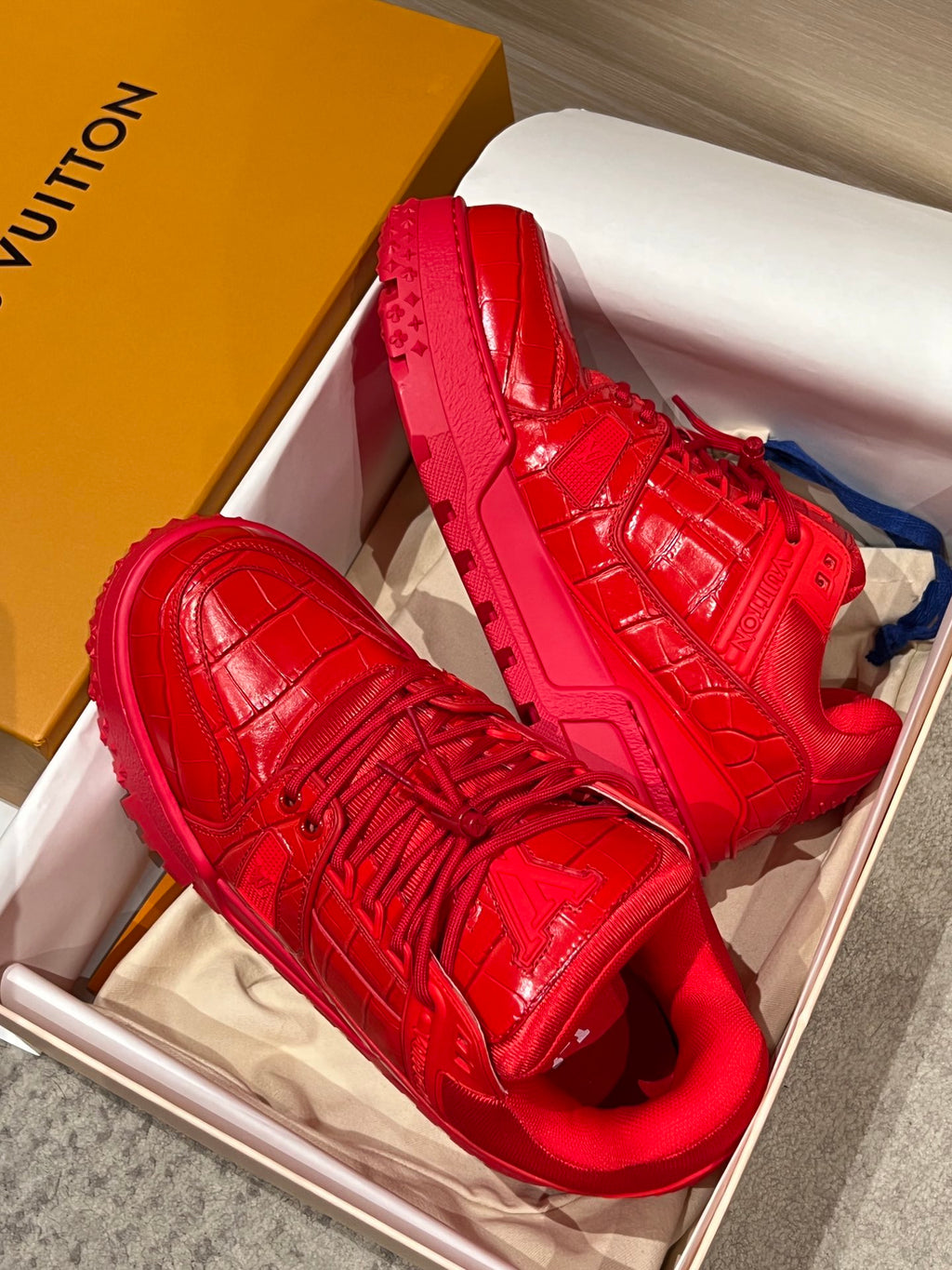 Louis Vuitton red trainer sneakers with embossed panels and lace-up upper