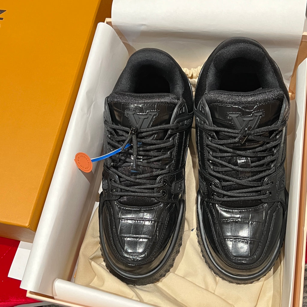 Black Louis Vuitton trainer sneakers in a box, shown front view pair.