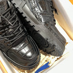 Black Louis Vuitton trainer sneakers close-up of laces, side, and tread sole.