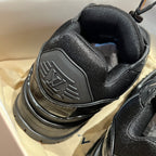 Black trainer sneaker heel and collar detail with cushioned lining.