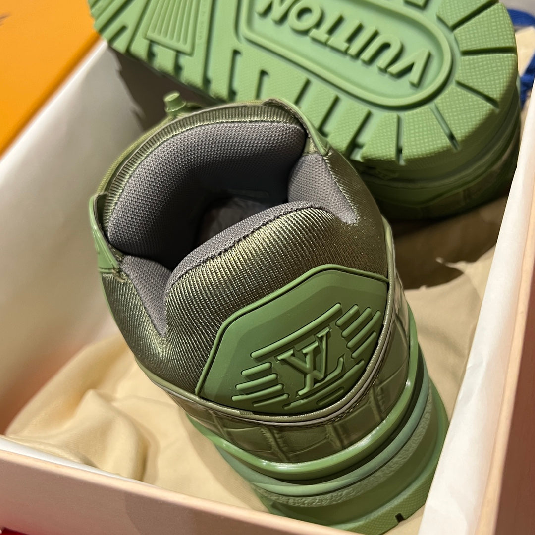 Green and gray trainer sneaker heel with textured outsole tread and embossed logo