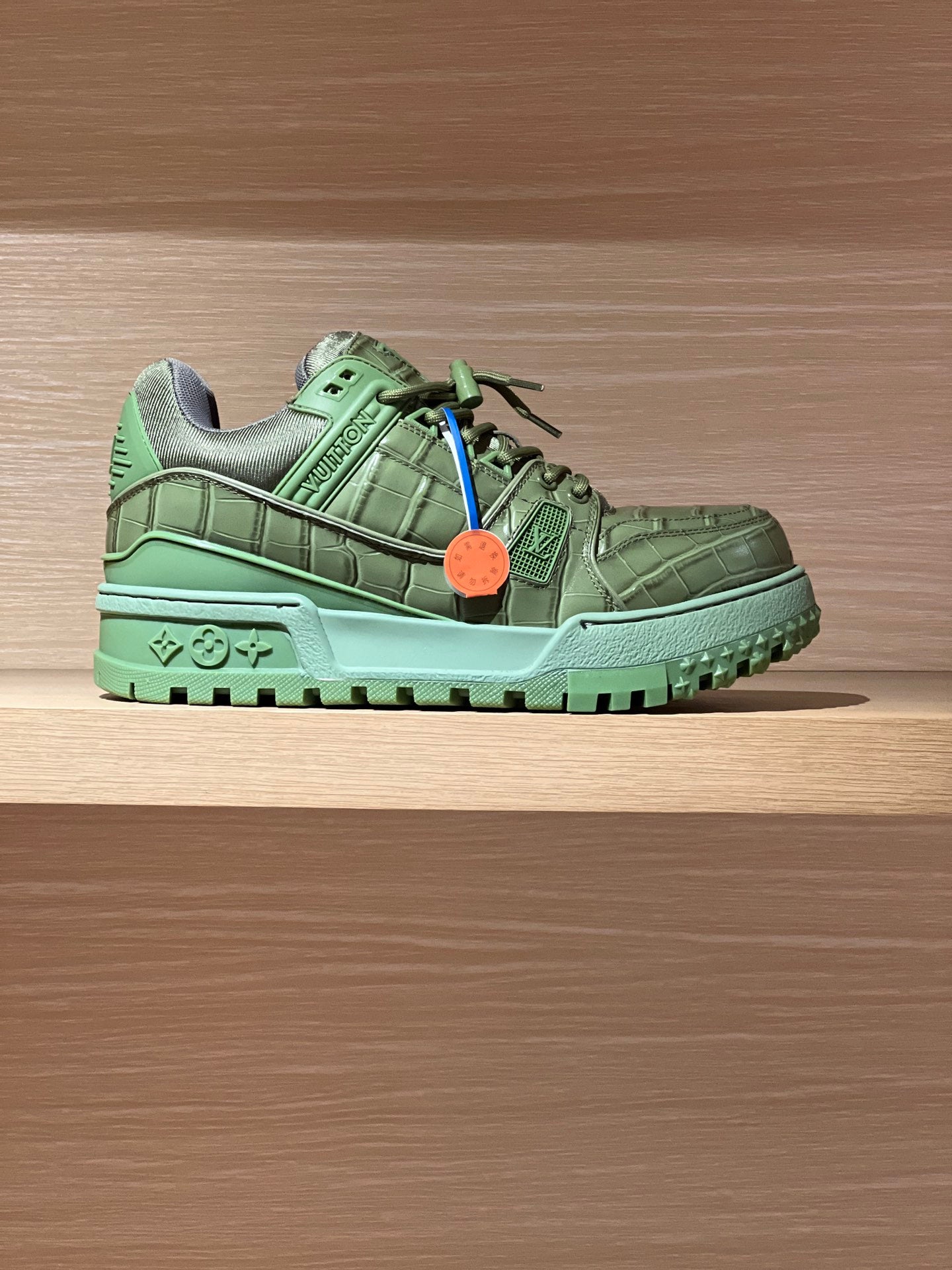 Green leather trainer sneaker with LV logo, lace-up front and chunky rubber sole