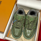 Green leather trainer sneakers in box, lace-up front with brand tongue logo