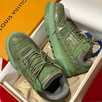 Green leather trainer sneakers in open box, high-top style and treaded outsole