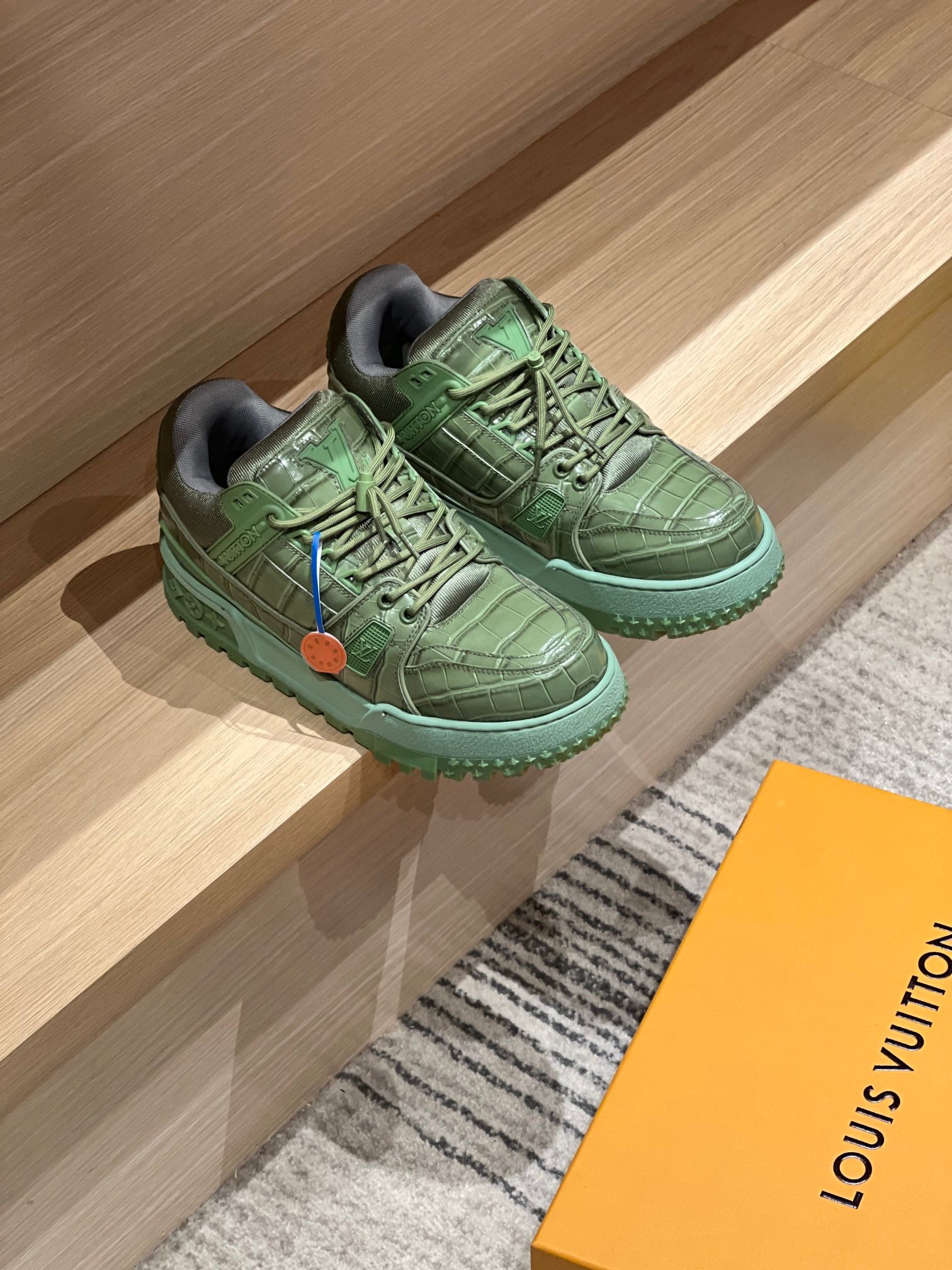 Green leather trainer shoes, lace-up with logo patch and thick tread sole