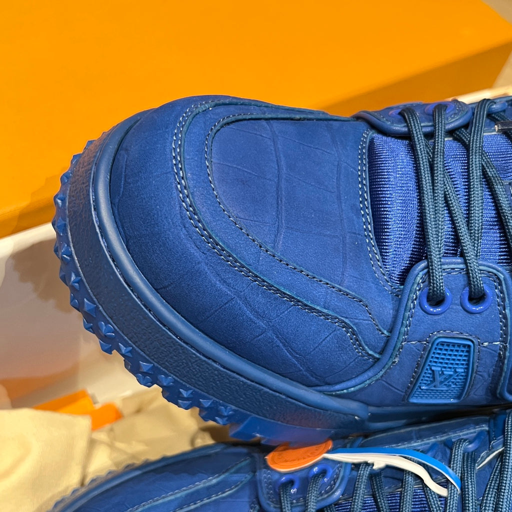 Louis Vuitton trainer shoe close-up, textured blue upper with chunky sole