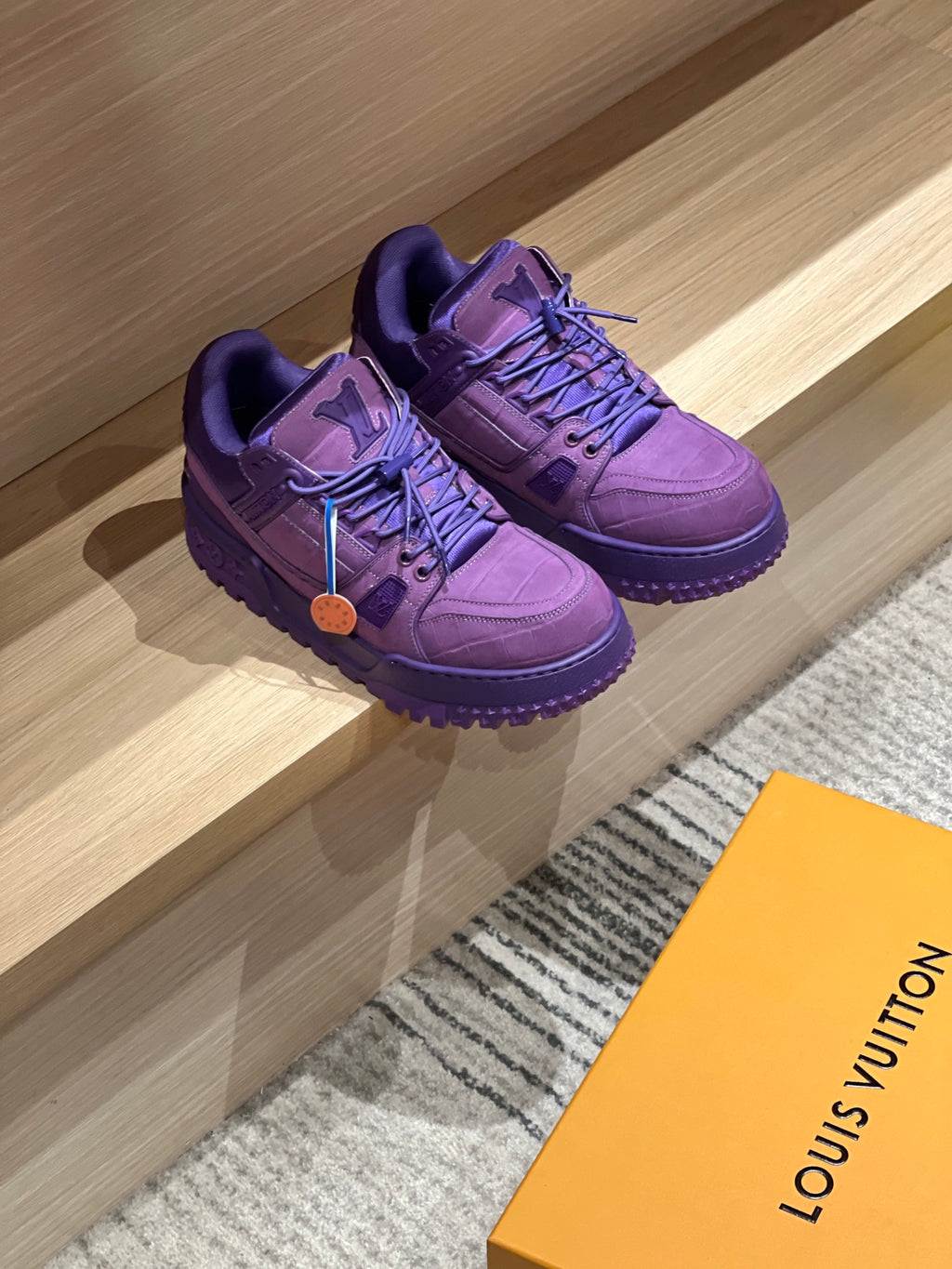Purple Louis Vuitton trainer sneakers, side view with lace-up straps and rugged sole