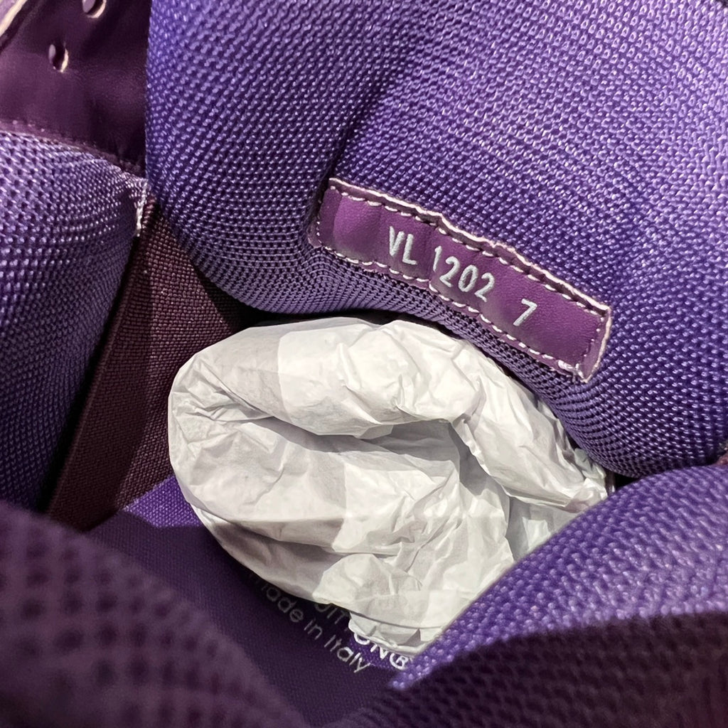 Purple sneaker interior label reading “VL 2027” on fabric trim