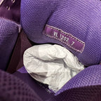 Purple sneaker interior label reading “VL 2027” on fabric trim