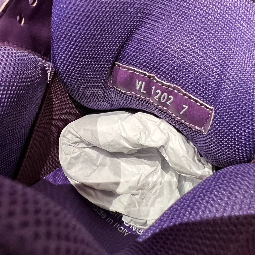 Purple sneaker interior label reading “VL 2027” on fabric trim