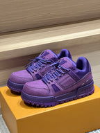 Purple Louis Vuitton trainer shoes on a box, lace-up design with textured sole