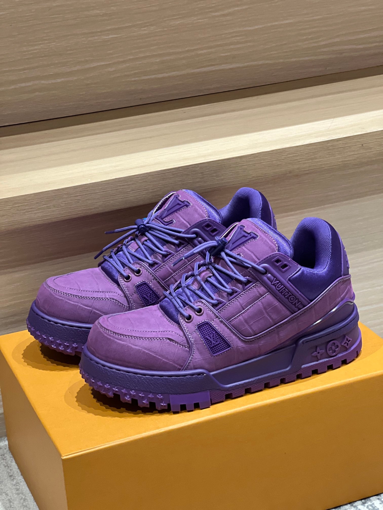Purple Louis Vuitton trainer shoes on a box, lace-up design with textured sole