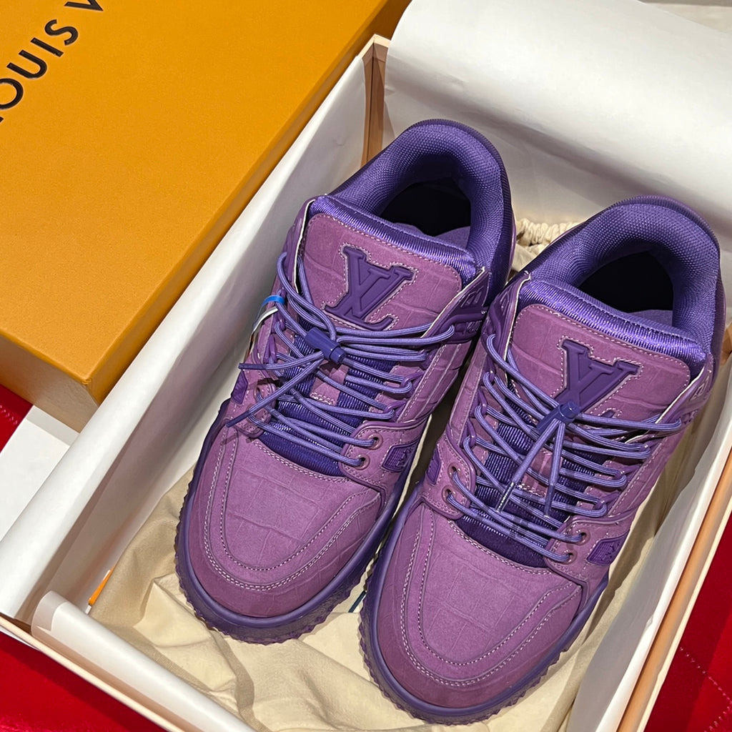 Pair of purple Louis Vuitton trainer shoes in a box with lace-up front and logo