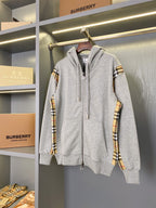 Hooded zip-up sweatshirt in heather gray with plaid sleeve panels and front zipper