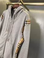 Heather gray zip-up hoodie with hood and plaid armband sleeve panel