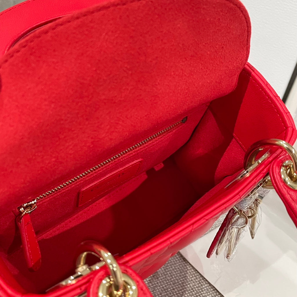 Red Dior handbag open interior with zipper pocket and gold key charm