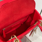Red Dior handbag open interior with zipper pocket and gold key charm
