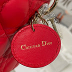Red Dior handbag round leather charm tag with “Christian Dior” text