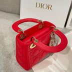 Red quilted Dior handbag with curved top handles and gold hardware