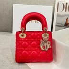 Red quilted Dior handbag with top handles and dangling charm detail