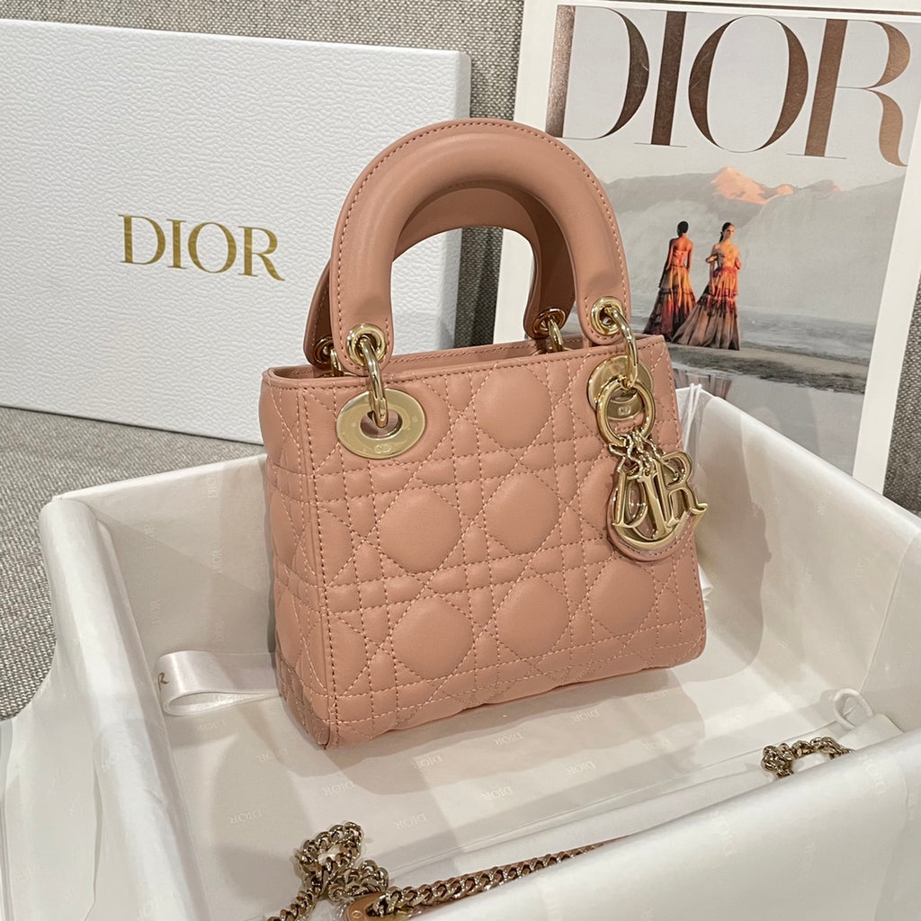 Dior mini handbag light pink quilted leather with top handles and small gold-tone charms