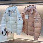 Long puffer jackets in light blue and pale pink, hood, front zip, chest pockets