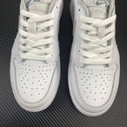 Air Jordan 1 low OG sneakers, top view showing white laces and perforated toe panels