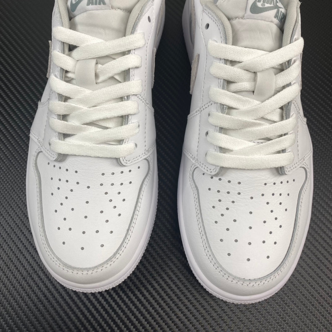 Air Jordan 1 low OG sneakers, top view showing white laces and perforated toe panels