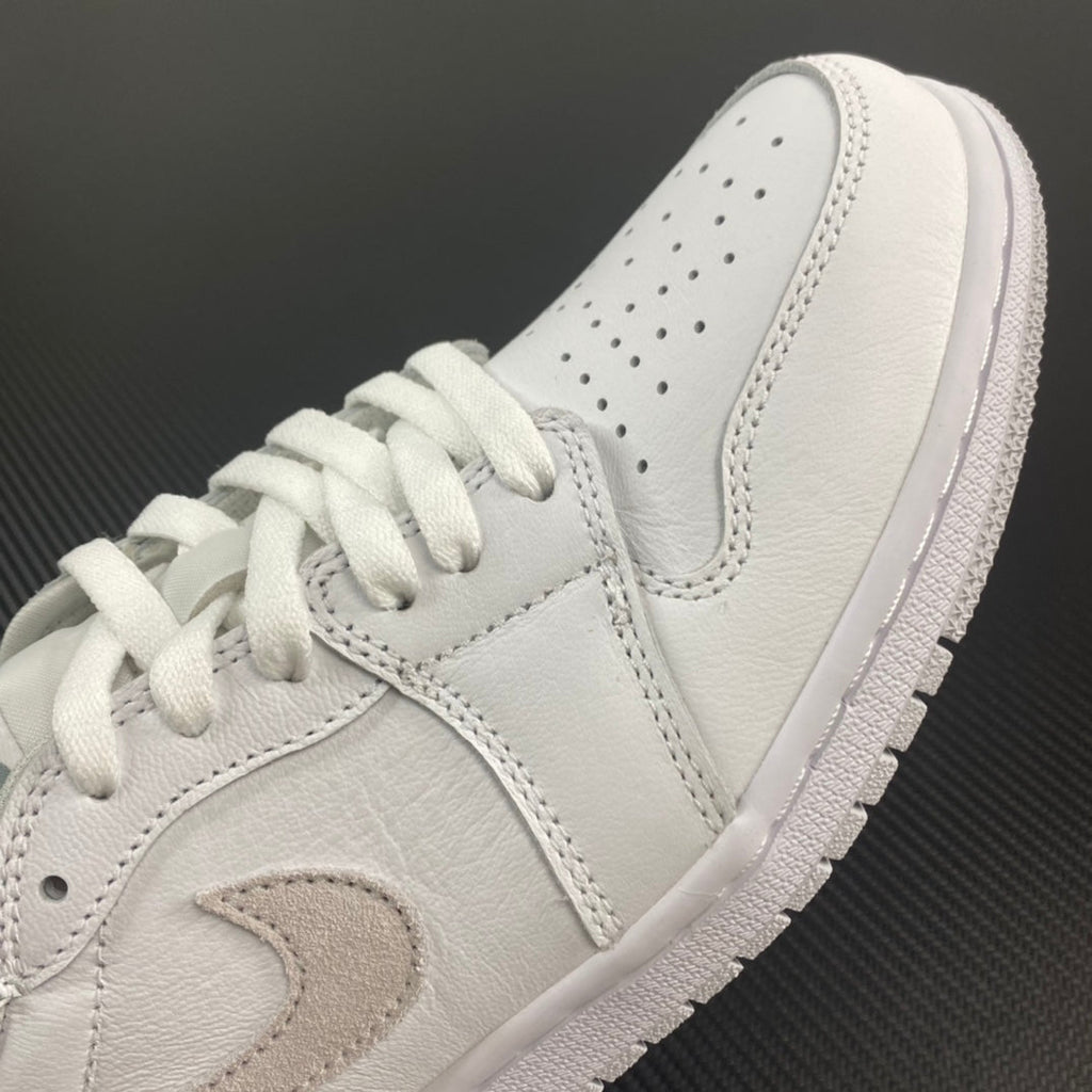 Air Jordan 1 low OG sneakers, close-up of white leather and perforated toe box