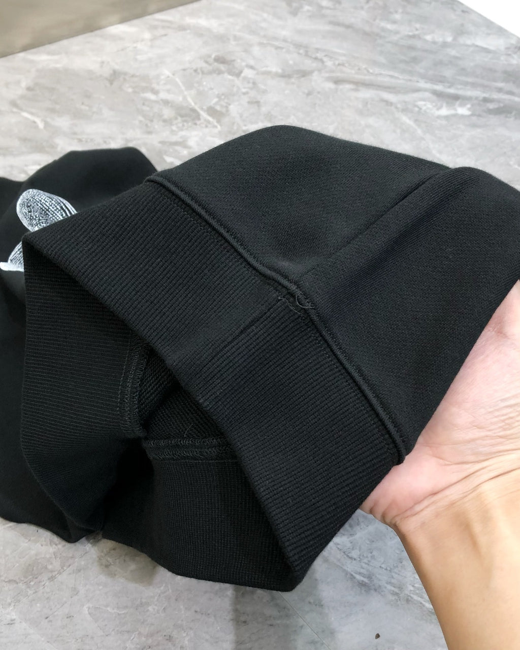 Black crewneck sweatshirt folded sleeve with ribbed cuff detail
