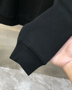 Black crewneck sweatshirt sleeve cuff with ribbed knit hem