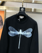 Black crewneck sweatshirt with blue dragonfly graphic and white center line