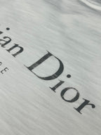 Dior short-sleeve T-shirt, close-up of large “Dior” logo print on white fabric