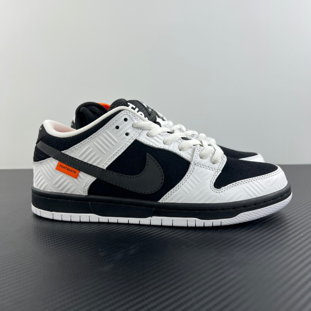 Black and white low-top sneakers with lace-up design and black Nike swoosh